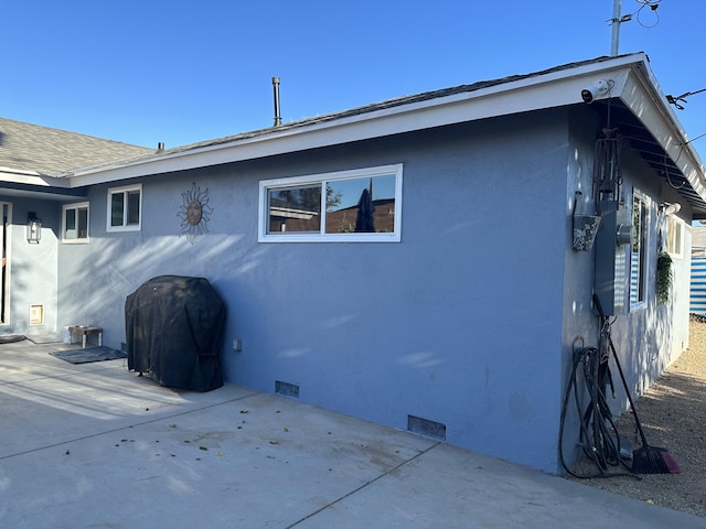 view of side of property featuring a patio