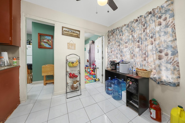 rec room with ceiling fan and light tile patterned floors