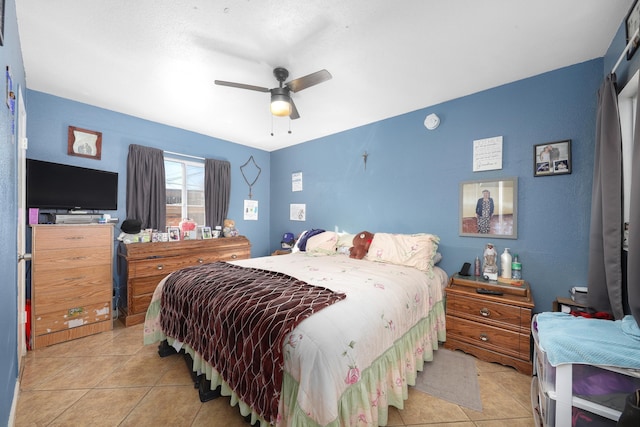 tiled bedroom featuring ceiling fan