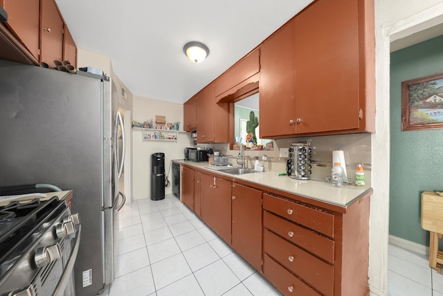 kitchen with sink, light tile patterned floors, and appliances with stainless steel finishes