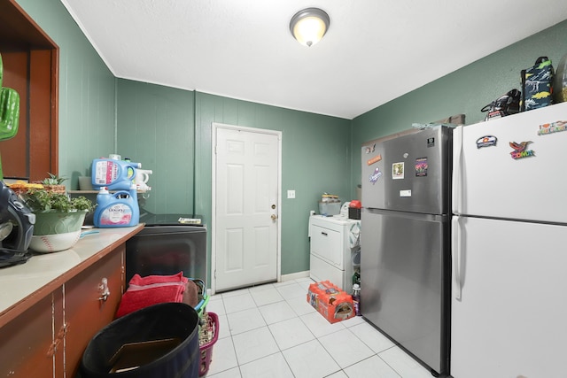 laundry area featuring washer / clothes dryer and light tile patterned floors