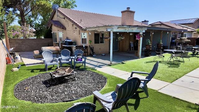 1519 Michelle Ave, Lancaster, CA 93535 - rear view of property featuring an outdoor fire pit, a chimney, a tile roof, stucco siding, and a patio area