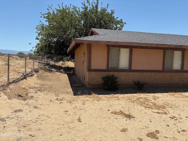 17306 Lakespring Ave, Palmdale, CA 93591 - view of side of property with roof with shingles