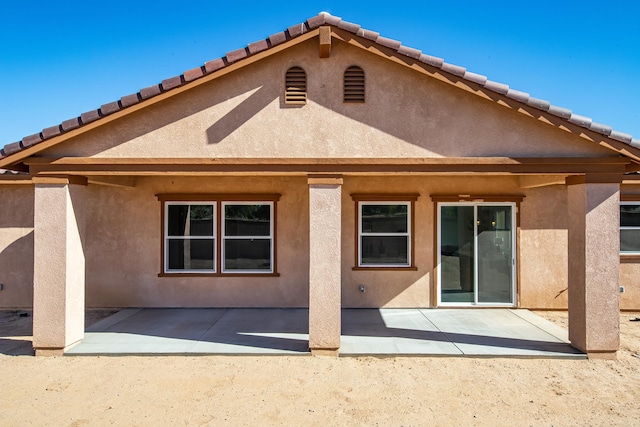 back of house with a patio