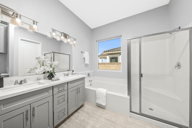 bathroom featuring separate shower and tub, vanity, and tile patterned flooring