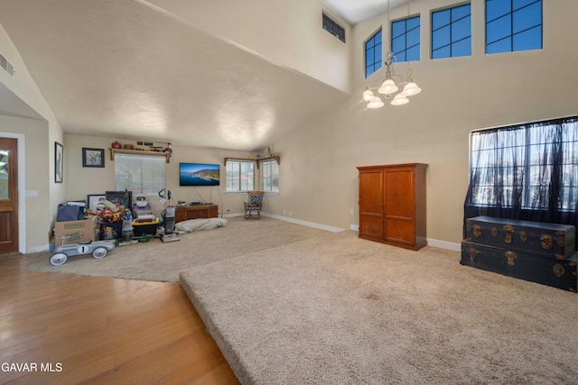2747 Wilson Ct, Lancaster, CA 93536 - living room featuring a chandelier, wood finished floors, and a high ceiling