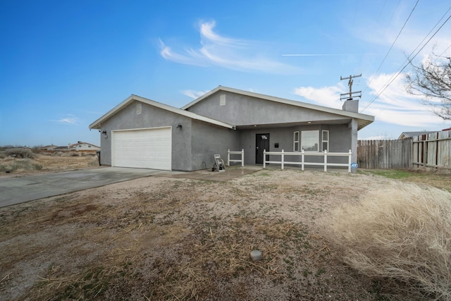 single story home with a chimney, stucco siding, fence, a garage, and driveway