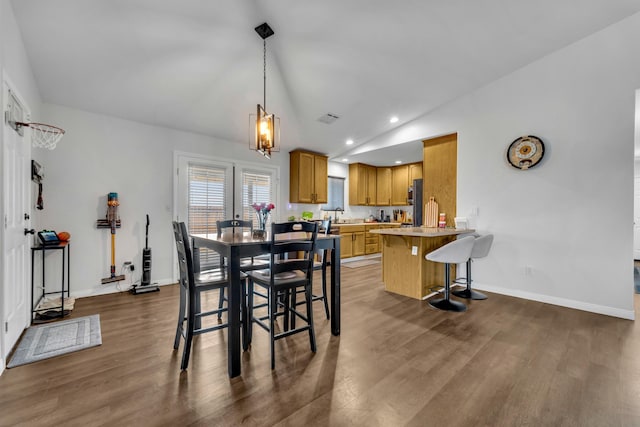 dining area with dark wood finished floors, lofted ceiling, recessed lighting, visible vents, and baseboards