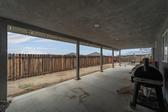 view of patio with a fenced backyard and a grill