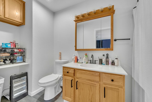 full bathroom with vanity, toilet, and baseboards