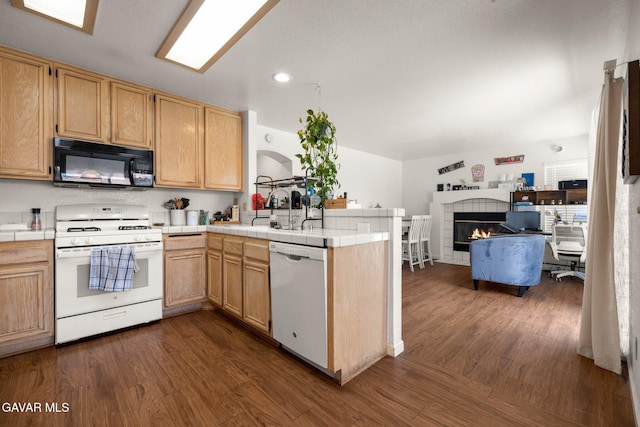 38030 Lido Dr, Palmdale, CA 93552 - kitchen with white appliances, tile countertops, a peninsula, dark wood finished floors, and recessed lighting