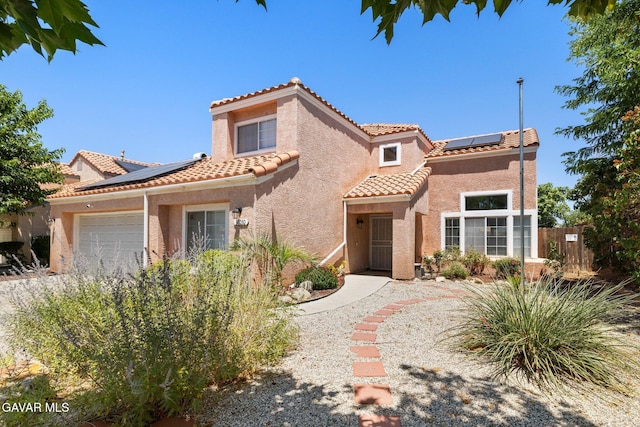 38030 Lido Dr, Palmdale, CA 93552 - mediterranean / spanish-style home featuring solar panels, a garage, a tile roof, and stucco siding