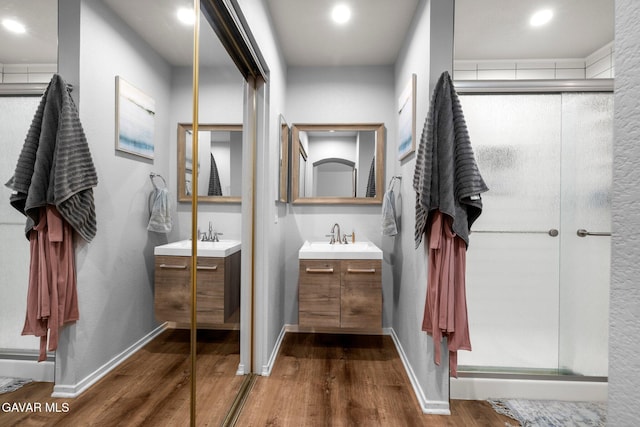 38030 Lido Dr, Palmdale, CA 93552 - full bathroom with wood finished floors, two vanities, a stall shower, and recessed lighting