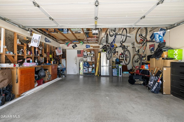 38030 Lido Dr, Palmdale, CA 93552 - garage with a garage door opener and a workshop area