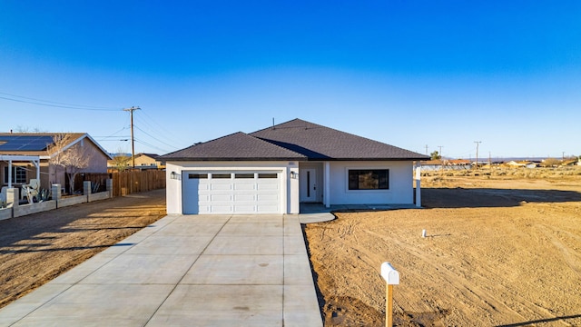 ranch-style house featuring fence, roof with shingles, driveway, stucco siding, and a garage