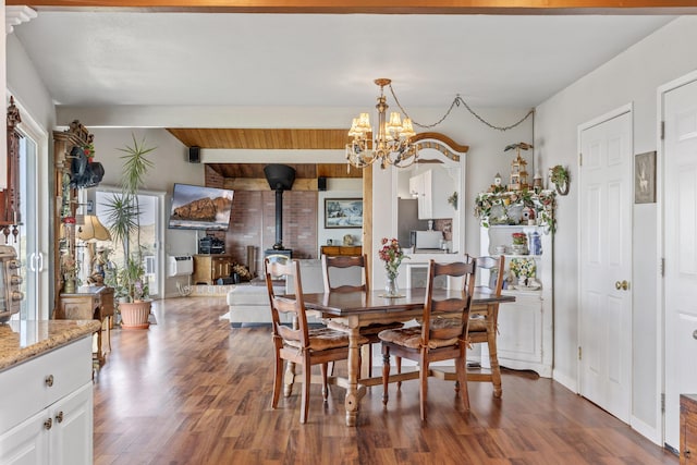 23761 El Rancho Dr, Tehachapi, CA 93561 - dining area featuring a wood stove, dark wood-style flooring, a chandelier, and beam ceiling