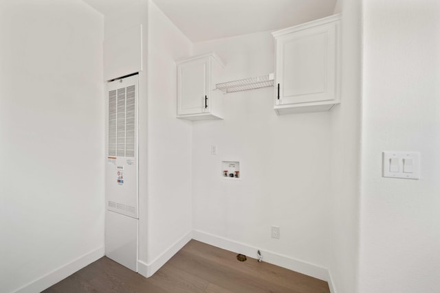 clothes washing area with washer hookup, cabinets, and dark wood-type flooring