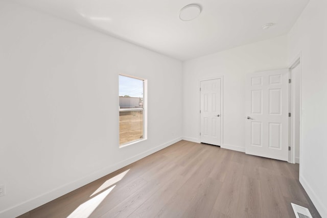 unfurnished bedroom featuring a closet and light hardwood / wood-style floors