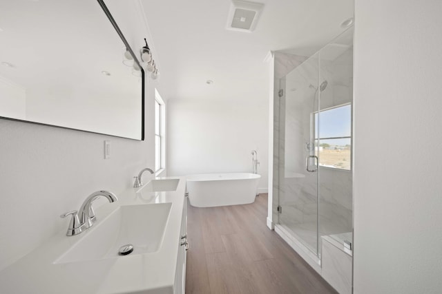 bathroom with vanity, plus walk in shower, and hardwood / wood-style flooring