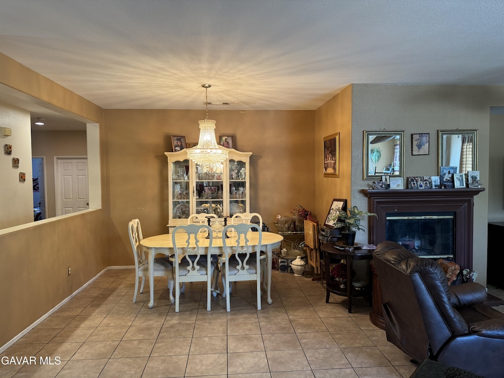 39300 Kennedy Dr, Palmdale, CA 93551 - tiled dining space featuring a glass covered fireplace