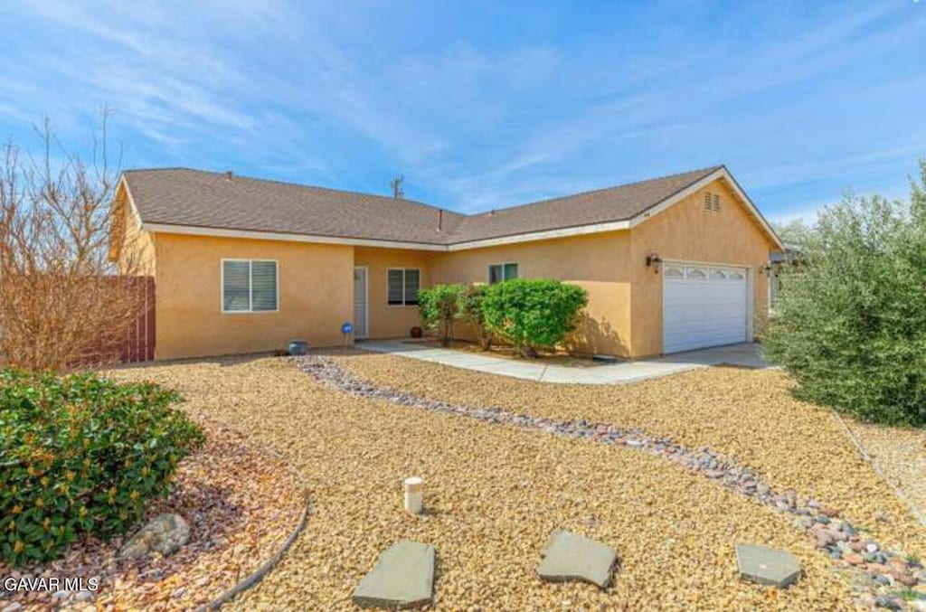 8400 Dogwood Ave, California City, CA 93505 - ranch-style house with a garage, stucco siding, and concrete driveway