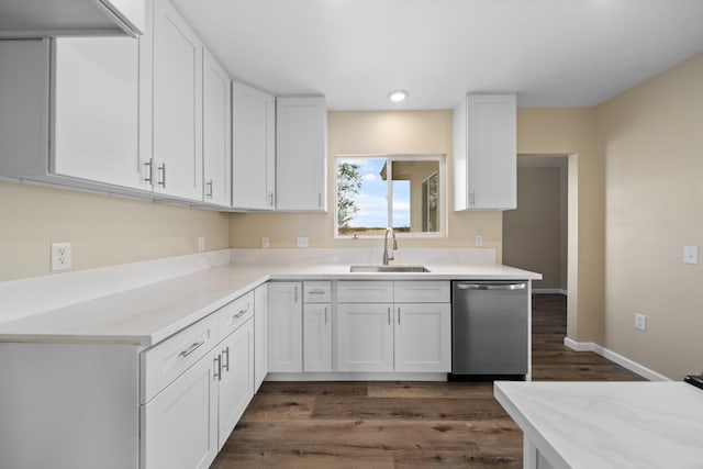 kitchen with a sink, dark wood-type flooring, dishwasher, light countertops, and white cabinets