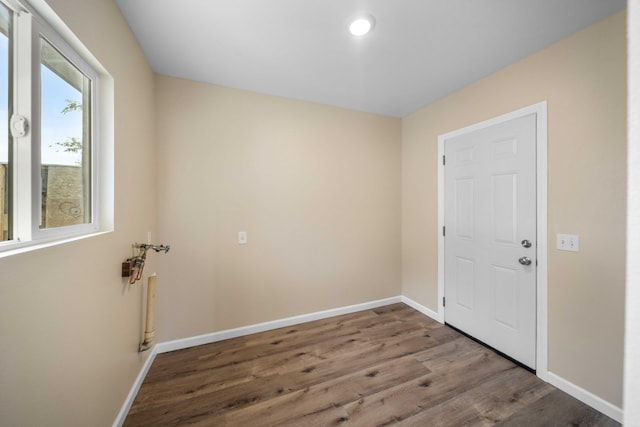 interior space featuring wood finished floors, baseboards, and recessed lighting