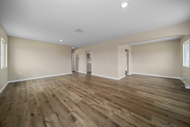 unfurnished living room with baseboards, recessed lighting, visible vents, and wood finished floors