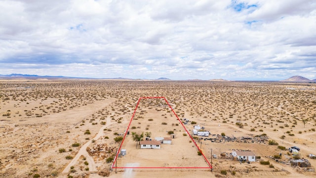 aerial view featuring a rural view, a desert view, and a mountain view