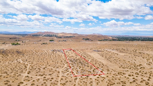 drone / aerial view with a rural view, view of desert, and a mountain view
