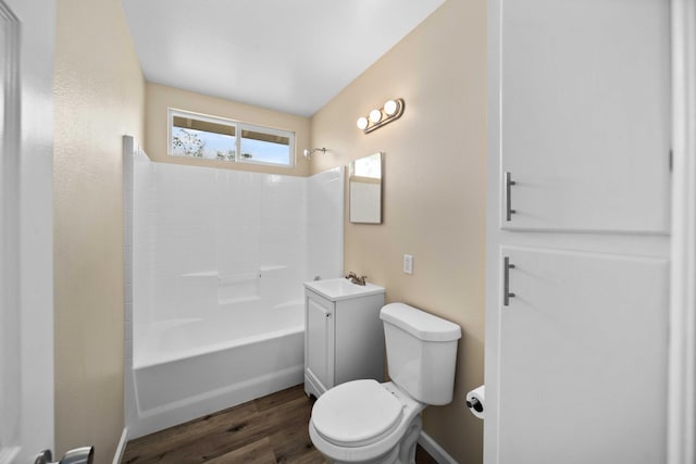 bathroom featuring toilet,  shower combination, baseboards, vanity, and wood finished floors