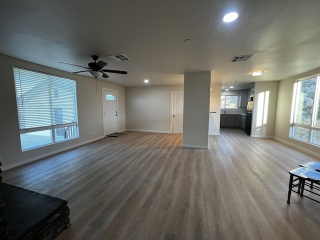 living room featuring hardwood / wood-style flooring and ceiling fan