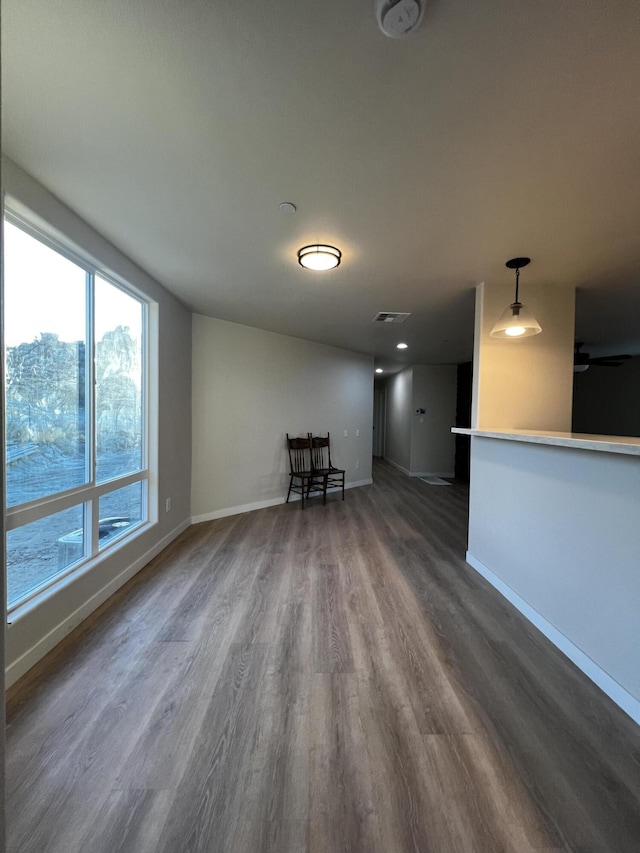 unfurnished living room with dark hardwood / wood-style flooring