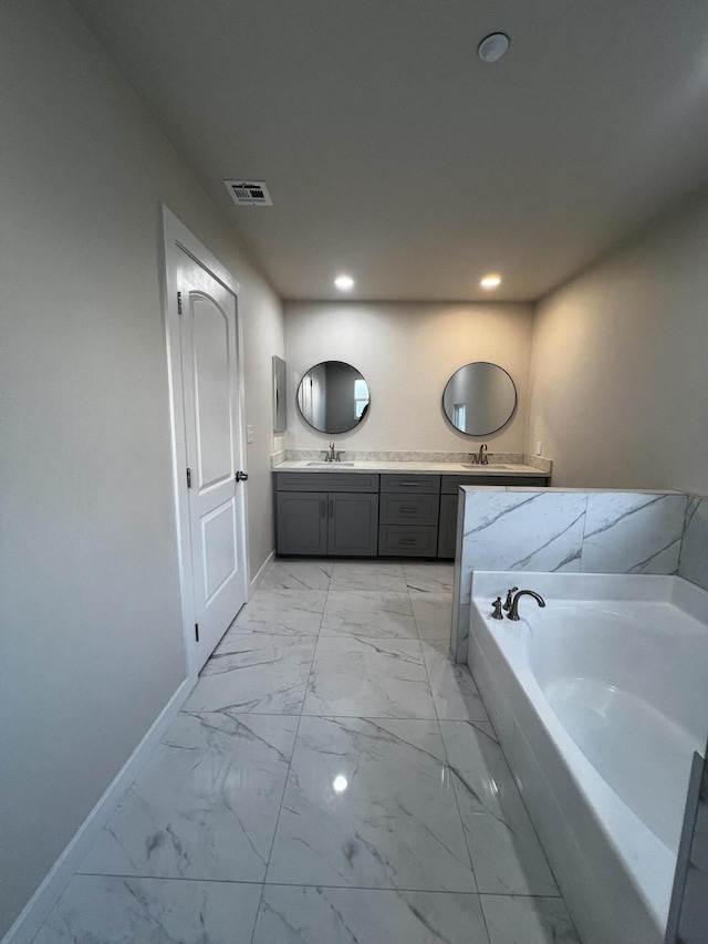 bathroom featuring vanity and a tub to relax in