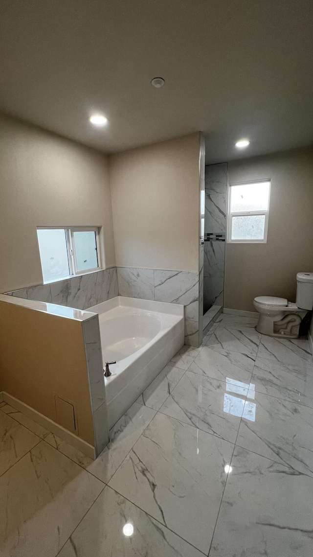 bathroom with separate shower and tub and toilet