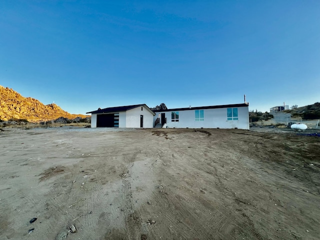 single story home featuring a mountain view and a garage