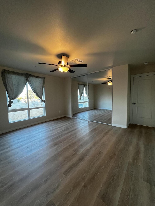 spare room featuring a wealth of natural light and wood-type flooring