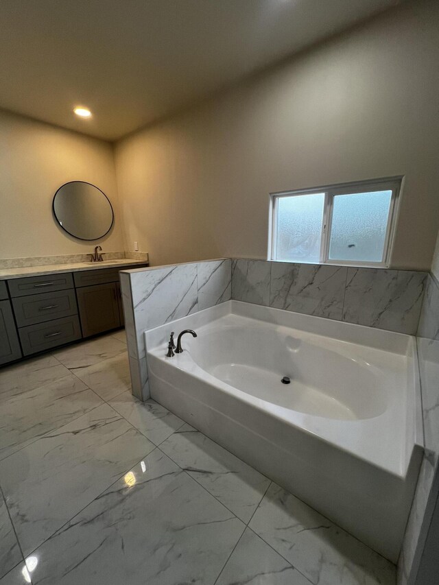 bathroom with vanity and a tub to relax in