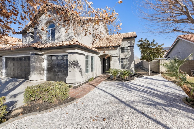 mediterranean / spanish house with a garage