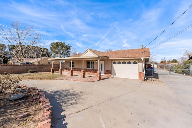 single story home featuring a garage, cooling unit, and covered porch