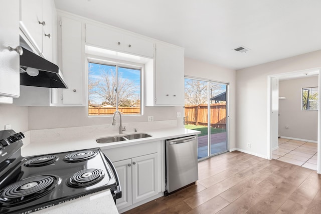 kitchen with a wealth of natural light, white cabinetry, sink, black electric range oven, and stainless steel dishwasher