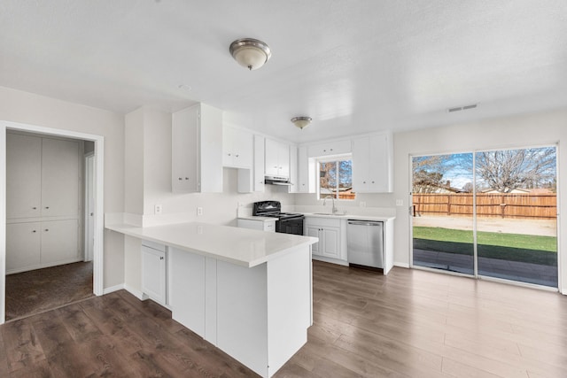 kitchen featuring dark hardwood / wood-style flooring, black electric range oven, stainless steel dishwasher, and white cabinets