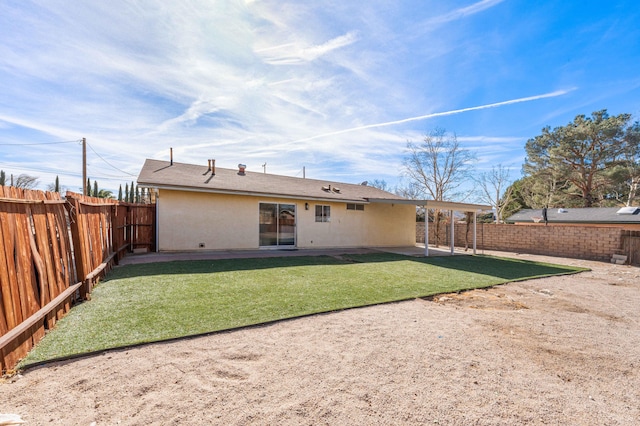 rear view of property with a yard and a patio area