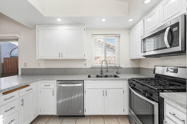 kitchen featuring white cabinets, stainless steel appliances, and sink