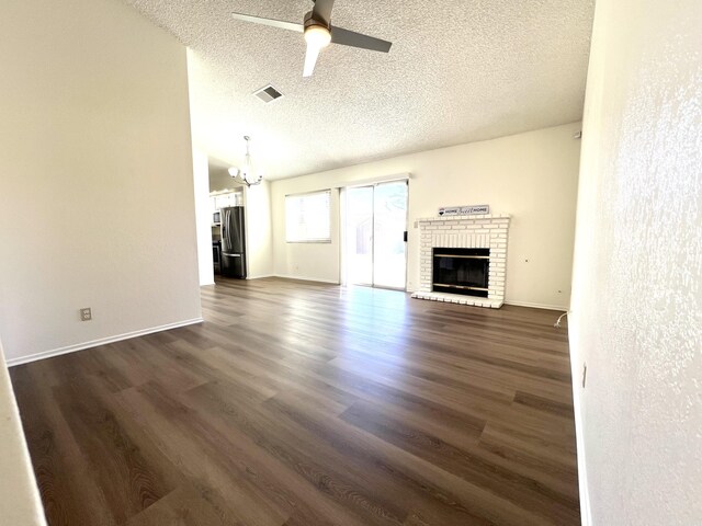 carpeted foyer with ceiling fan, a fireplace, and a textured ceiling