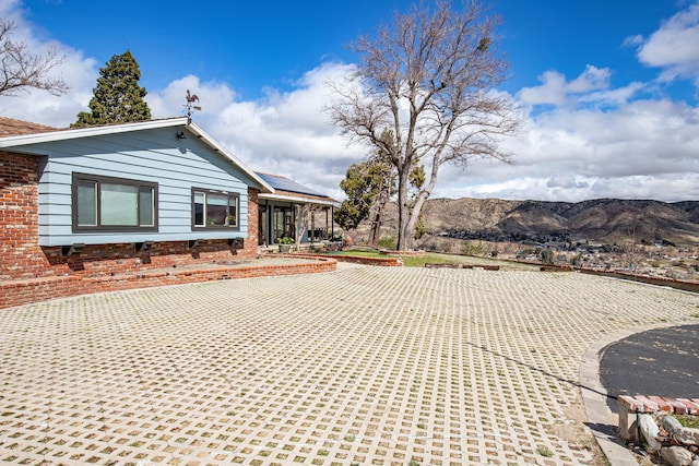 exterior space featuring solar panels and a mountain view