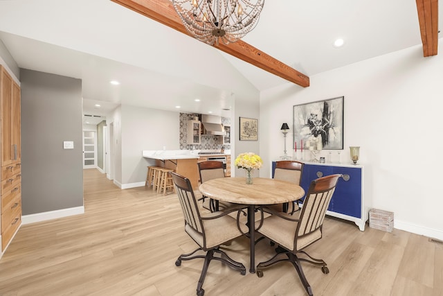 dining room with a notable chandelier, baseboards, lofted ceiling with beams, and light wood-style floors