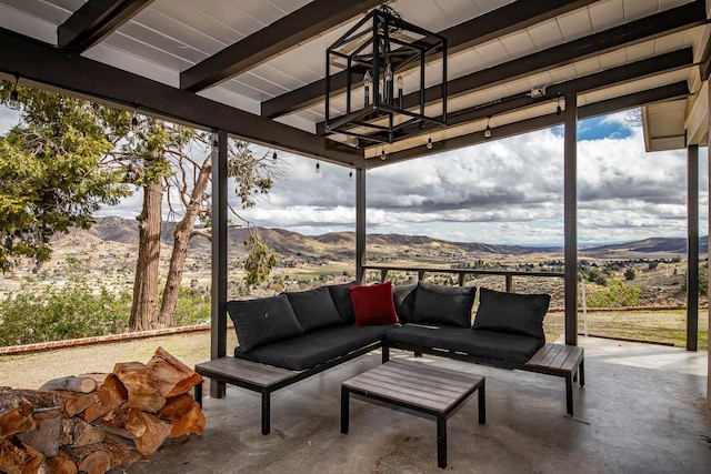 view of patio with an outdoor living space and a mountain view