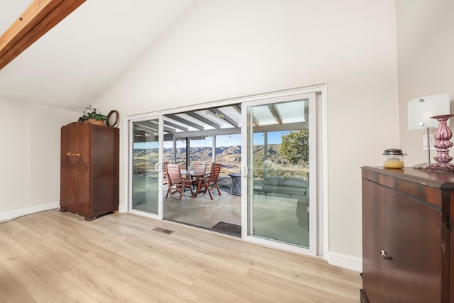 dining space with visible vents, high vaulted ceiling, light wood-type flooring, and baseboards