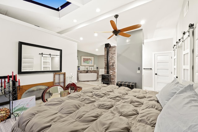 bedroom with visible vents, lofted ceiling with beams, a wood stove, recessed lighting, and a barn door